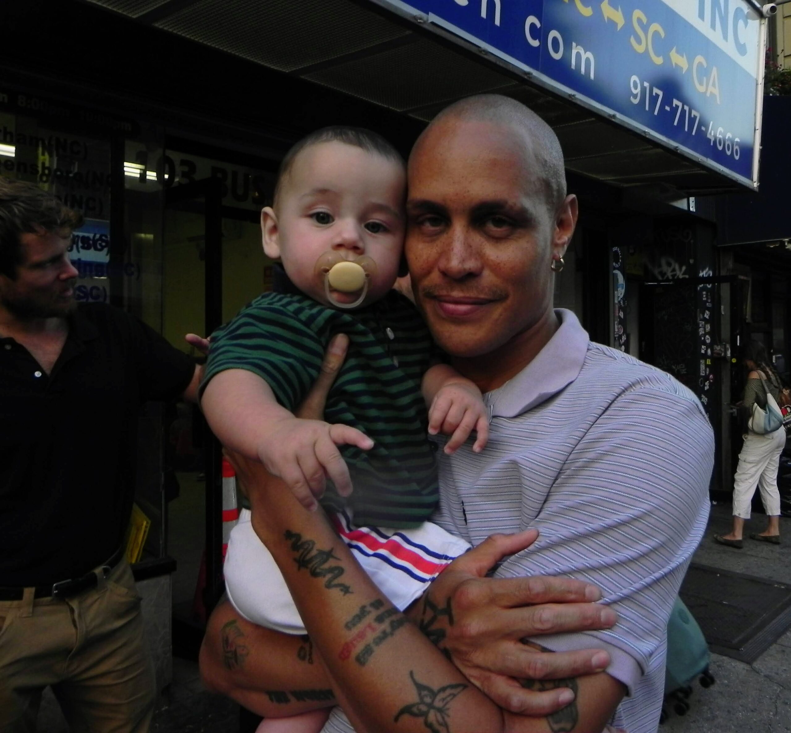Quentin Belt is holding a baby.