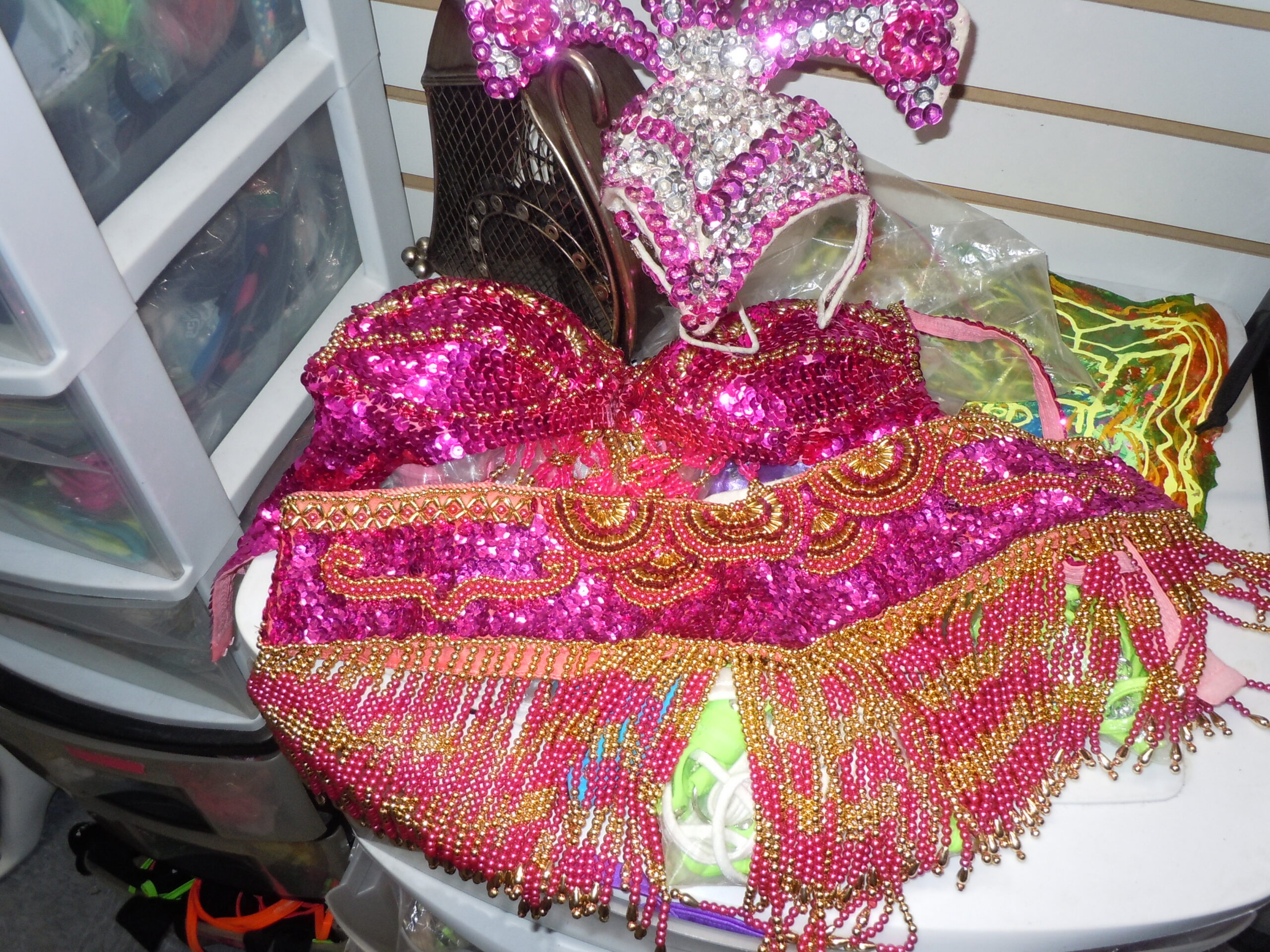 A pink and orange bedazzled carnival showgirl bra and skirt.
