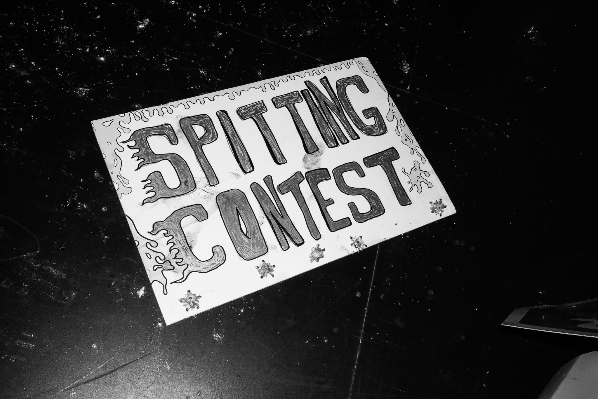 A sign that reads "Spitting Contest".