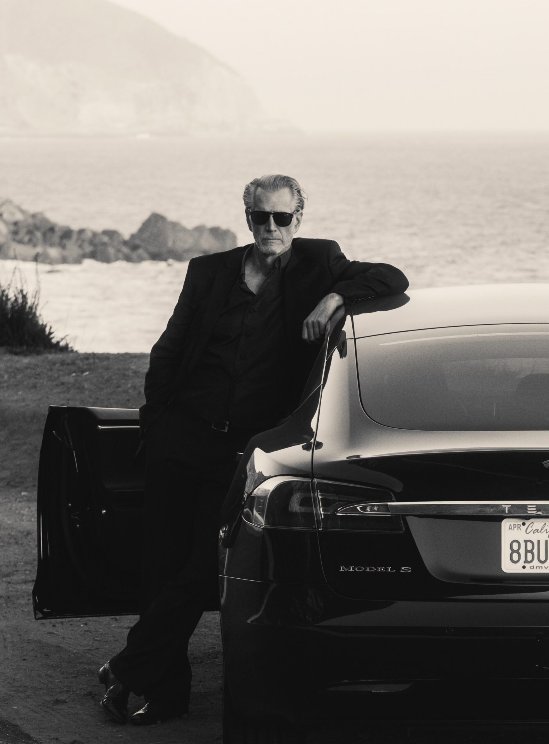 Hoyt Richards leaning against a sports car