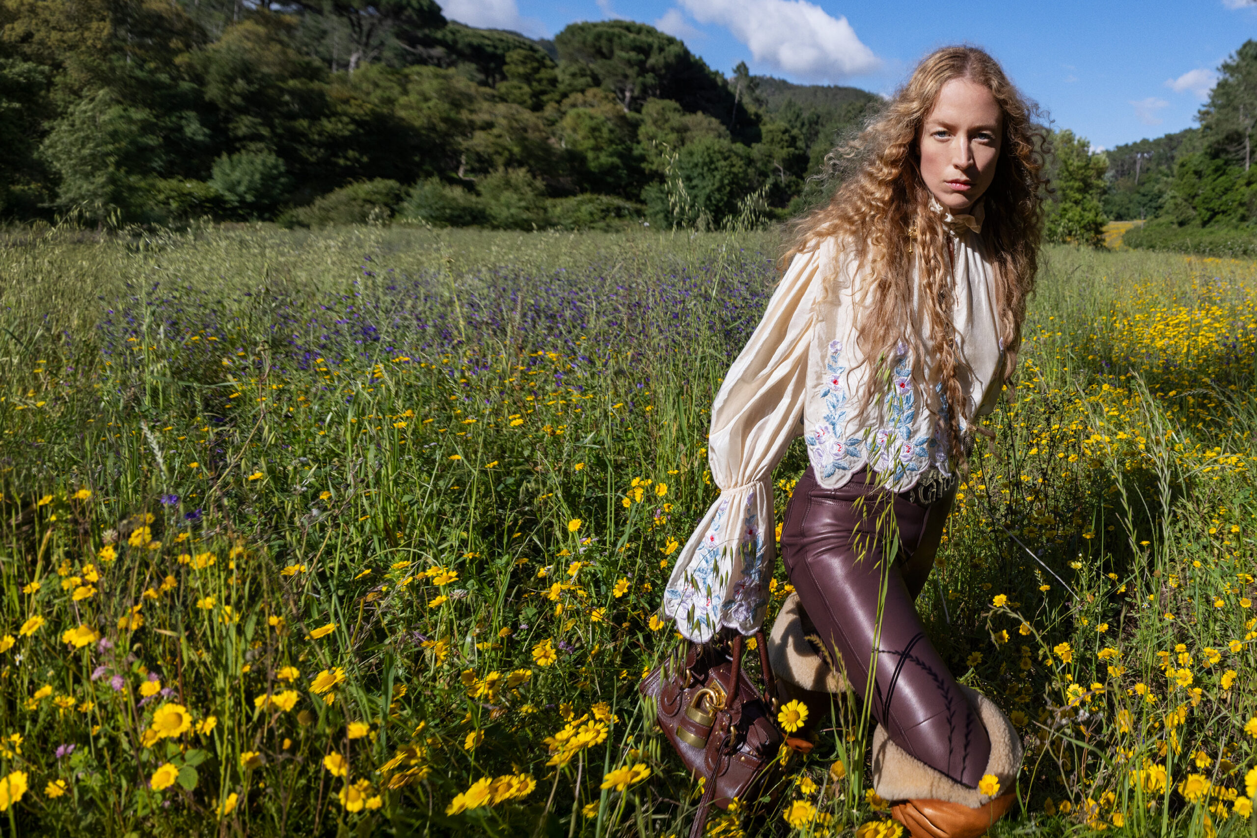 A model wearing Chloe models in a field of sunflowers.