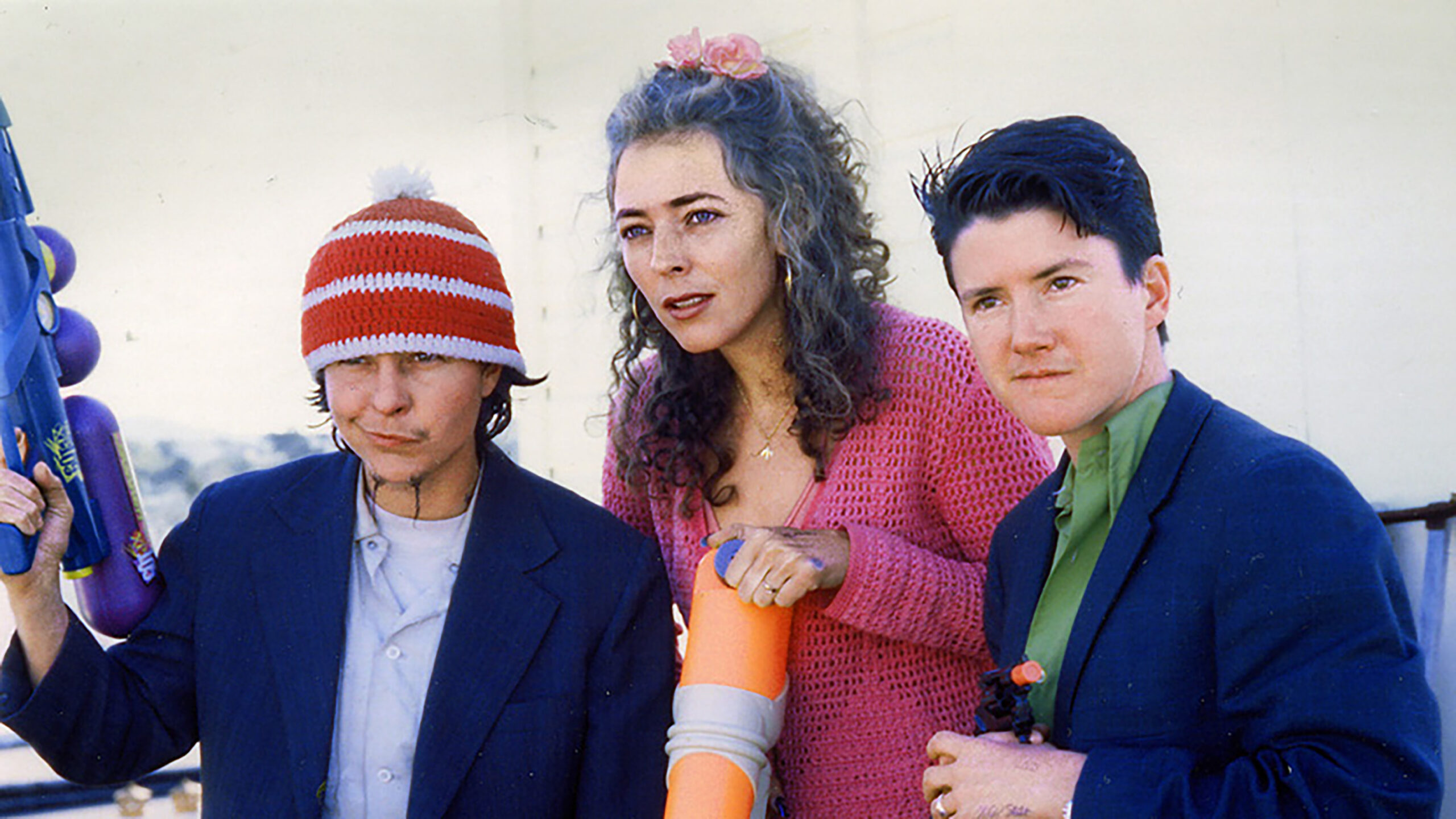 Harry Dodge, Stanya Kahn, and Silas Howard standing together and looking out in the distance in a film still from By Hook or By Crook