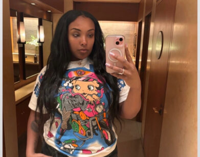 Aida Osman taking a selfie wearing a Bettie Boop t-shirt