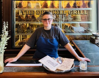 April Bloomfield standing behind the bar at The Driskill Grill