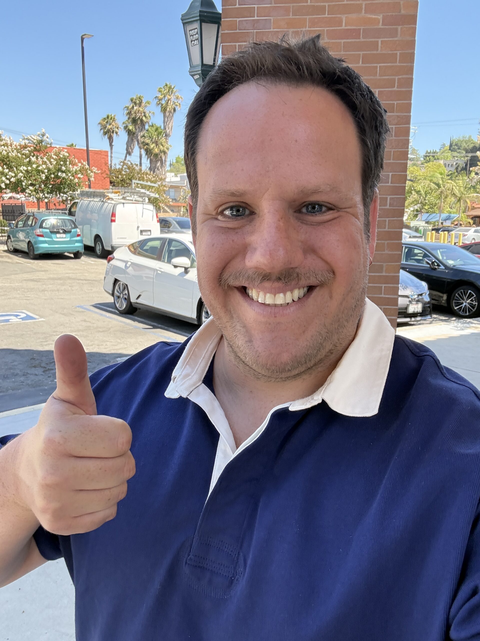 Adam Rotstein thumbs up to the camera.