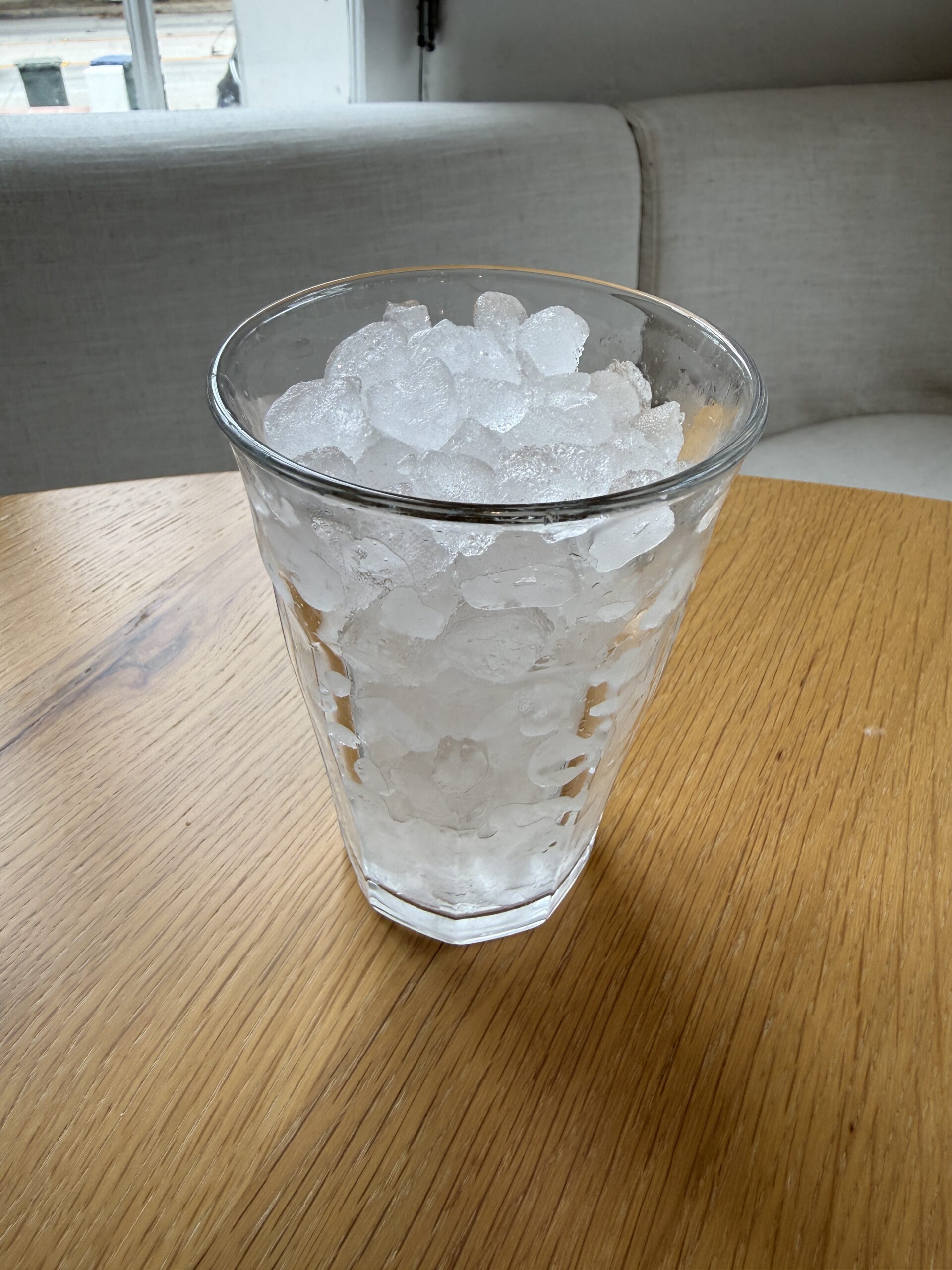 A glass cup filled with pebble ice.