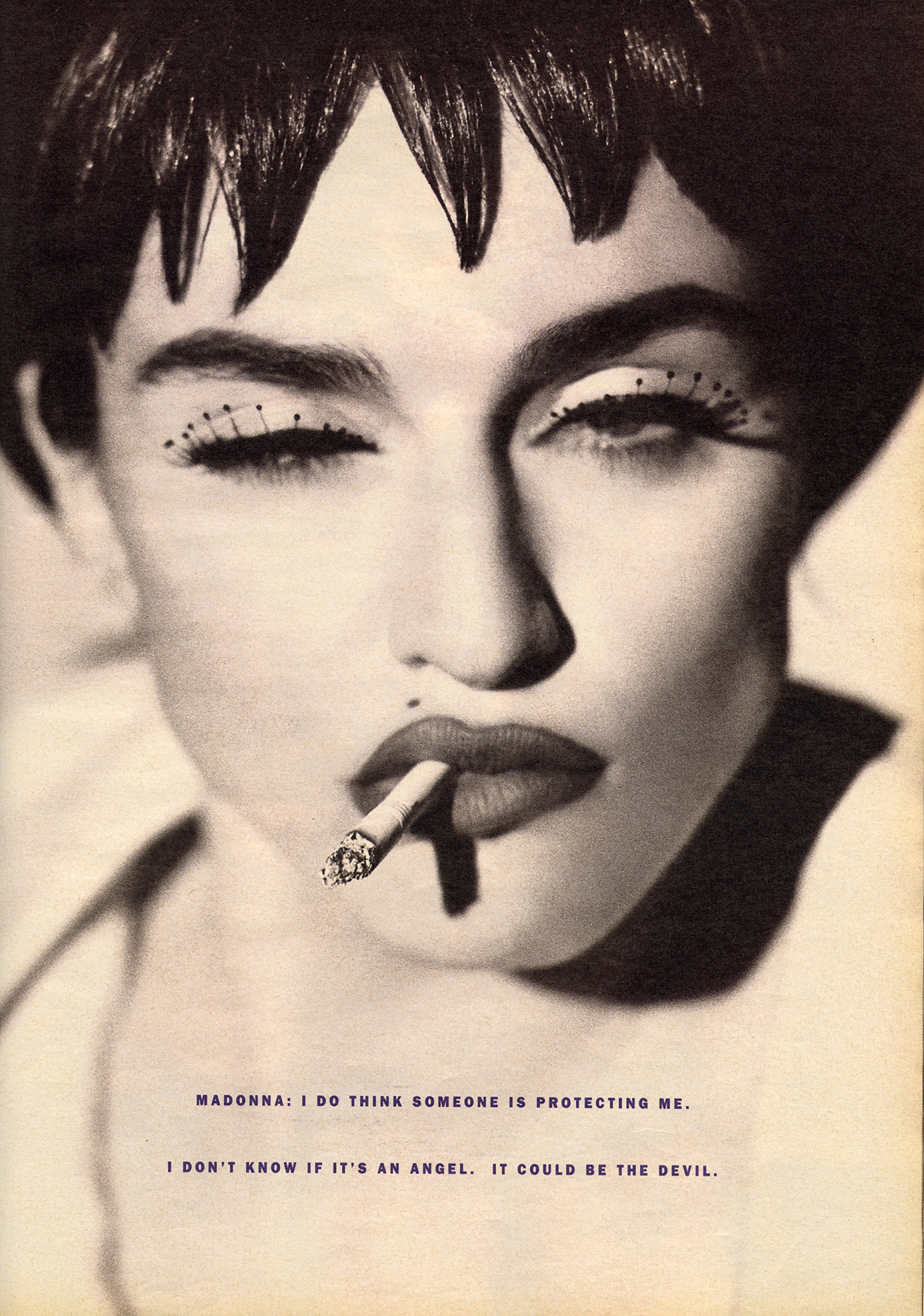 Close up of Madonna smoking a cigarette.