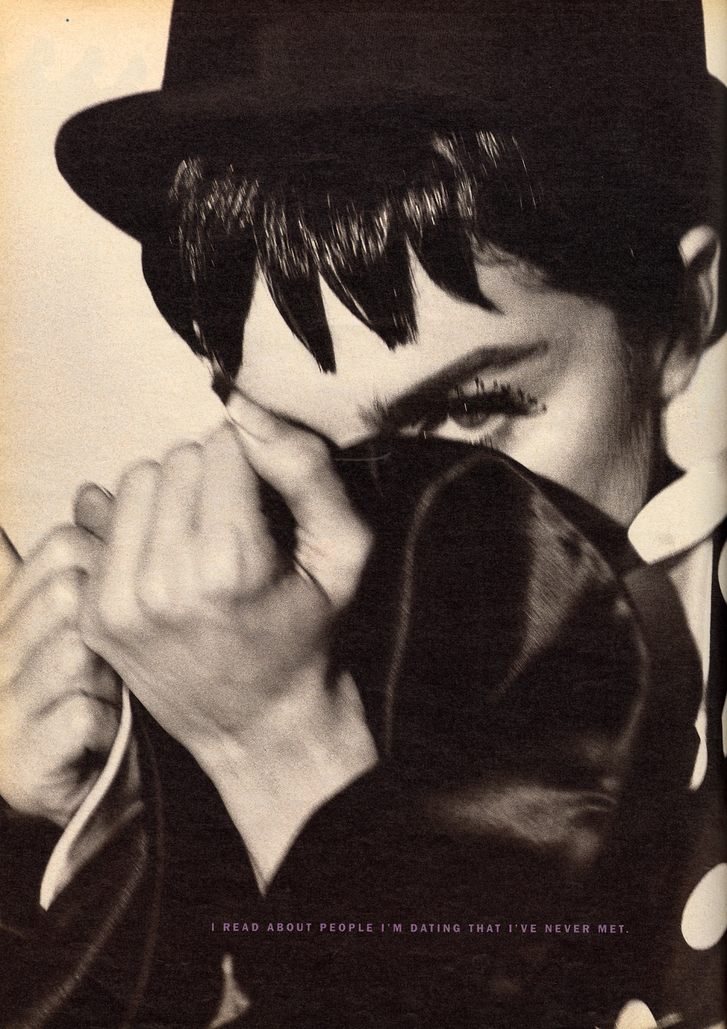 Close up of Madonna staring at camera, one eye is covered by top hat.