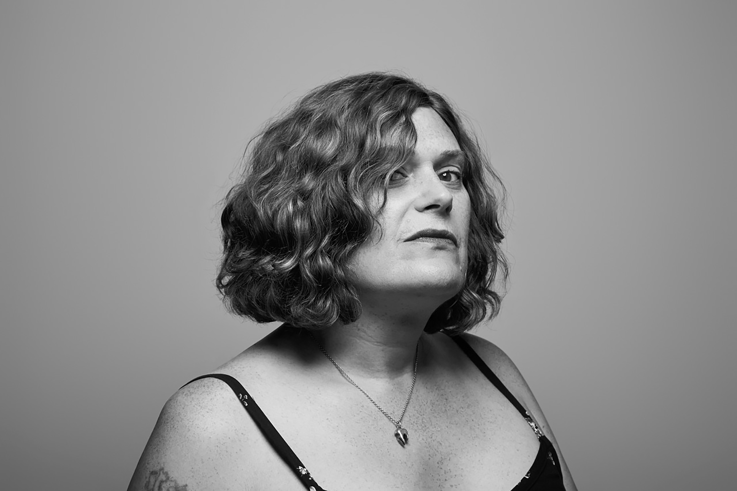 A black and white image of Lilly Wachowski looking at the camera