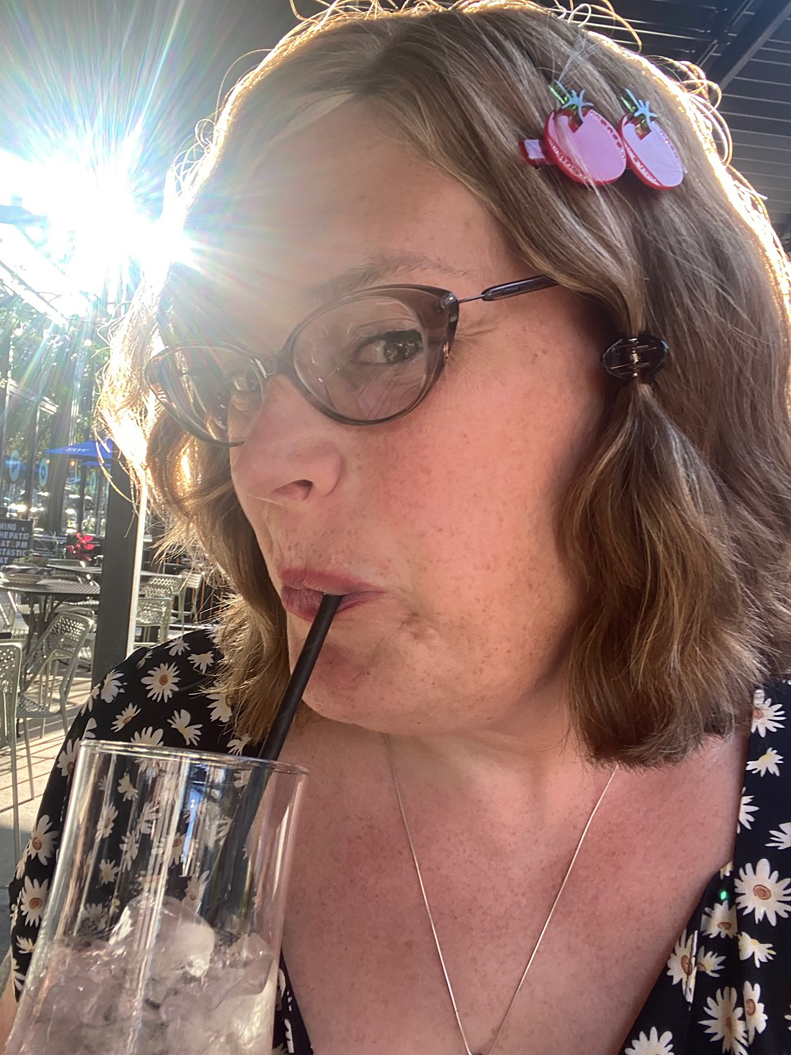 Lilly Wachowski looking at the camera in a selfie while sipping a drink