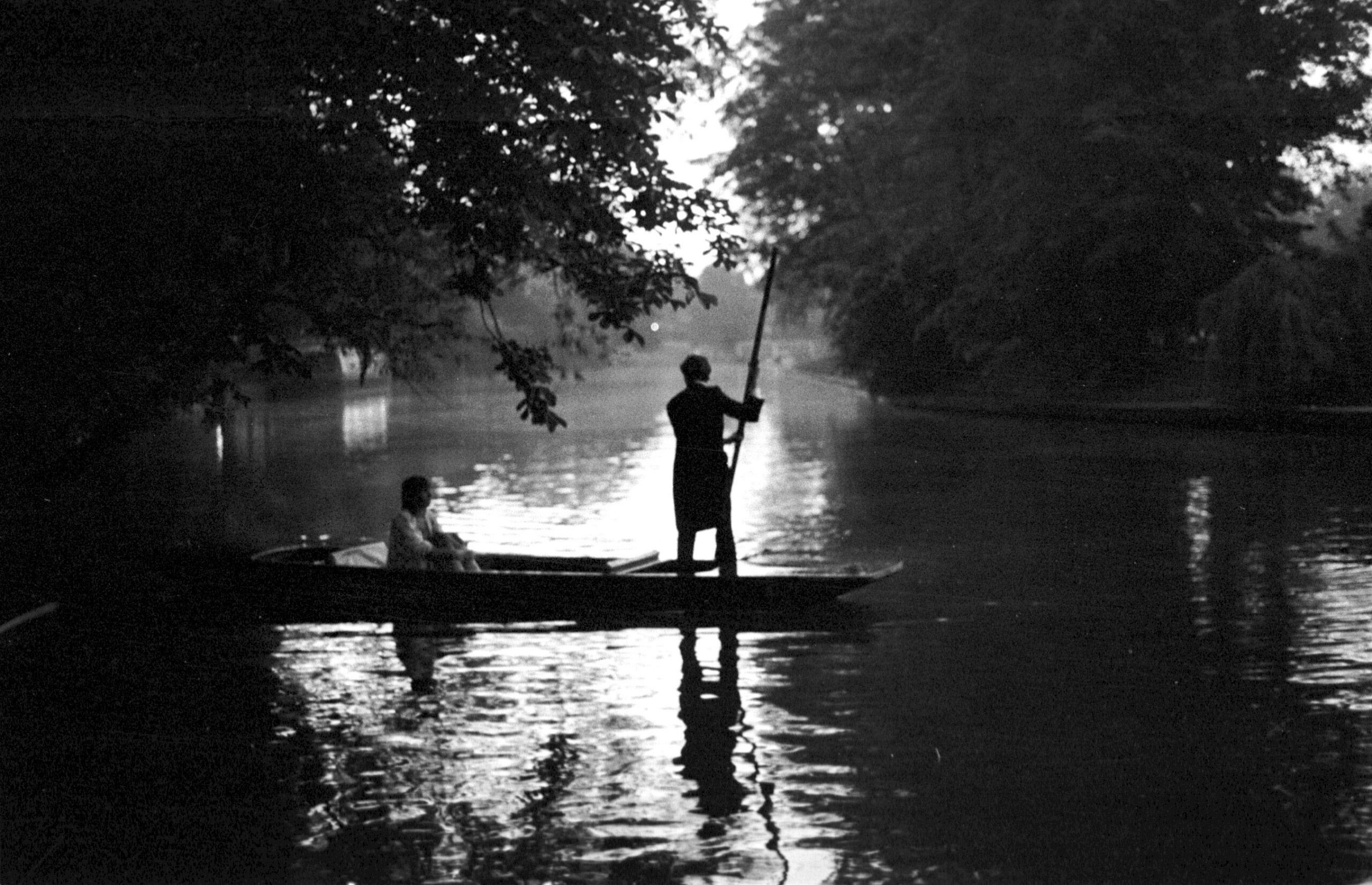 Scenic landscape of a man rowing a boat at Cambridge May Ball