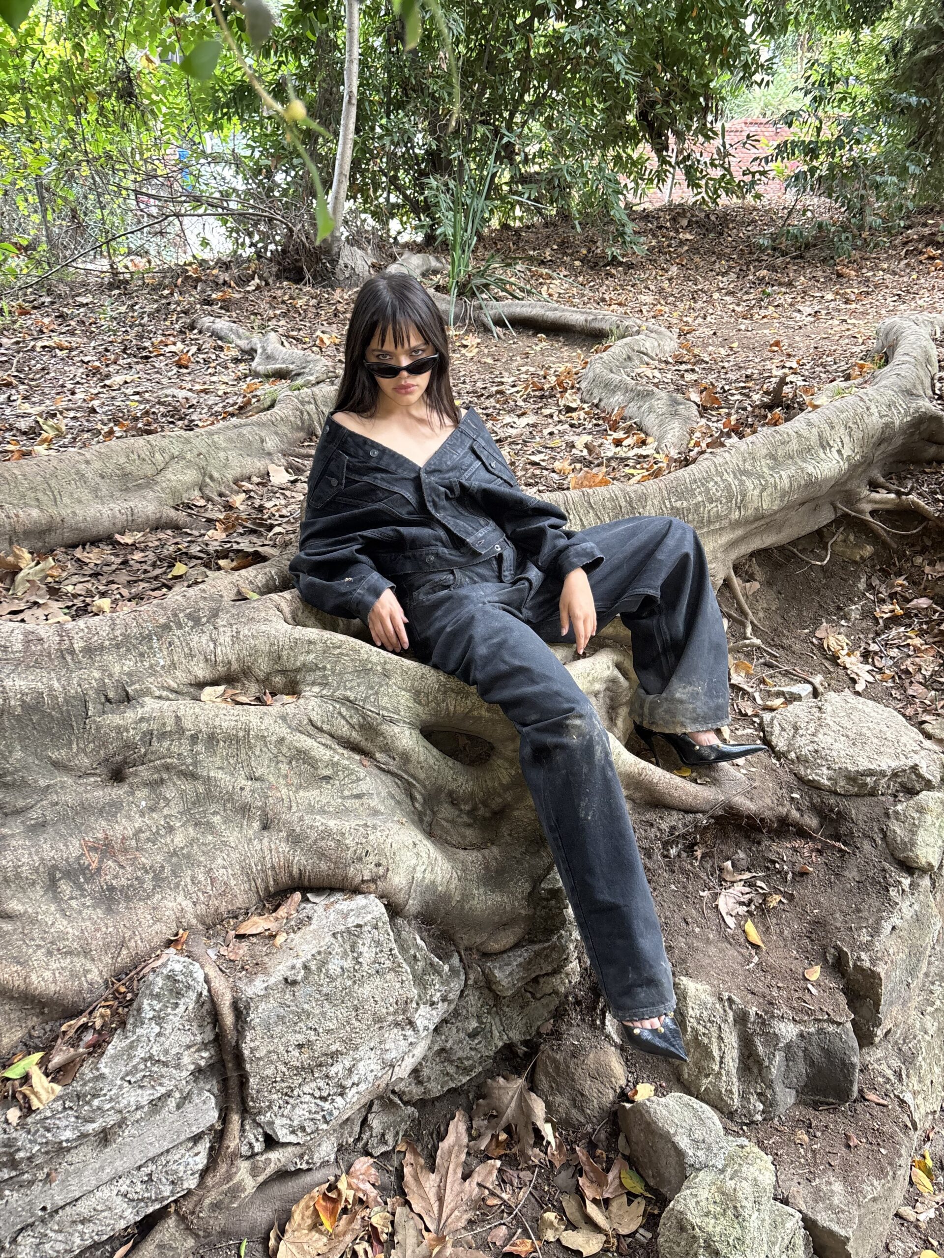 Malia Pyles lying down on tree roots