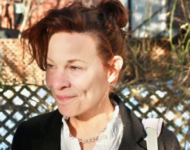 A photo of Lili Taylor with her hair in a bun