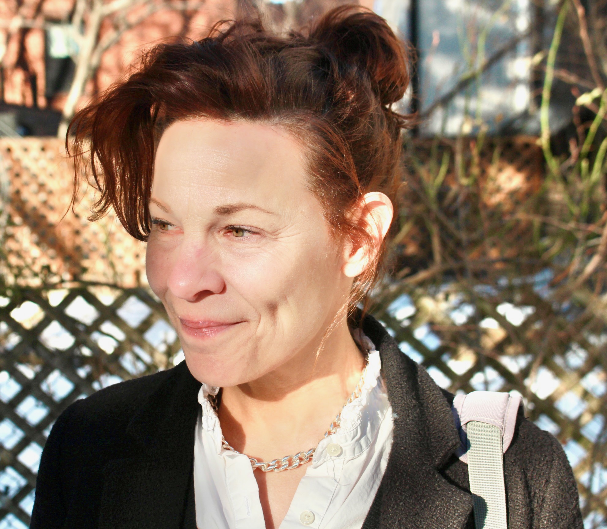 A photo of Lili Taylor with her hair in a bun
