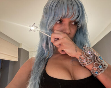 Cannelle holding a sparkly wand in a selfie