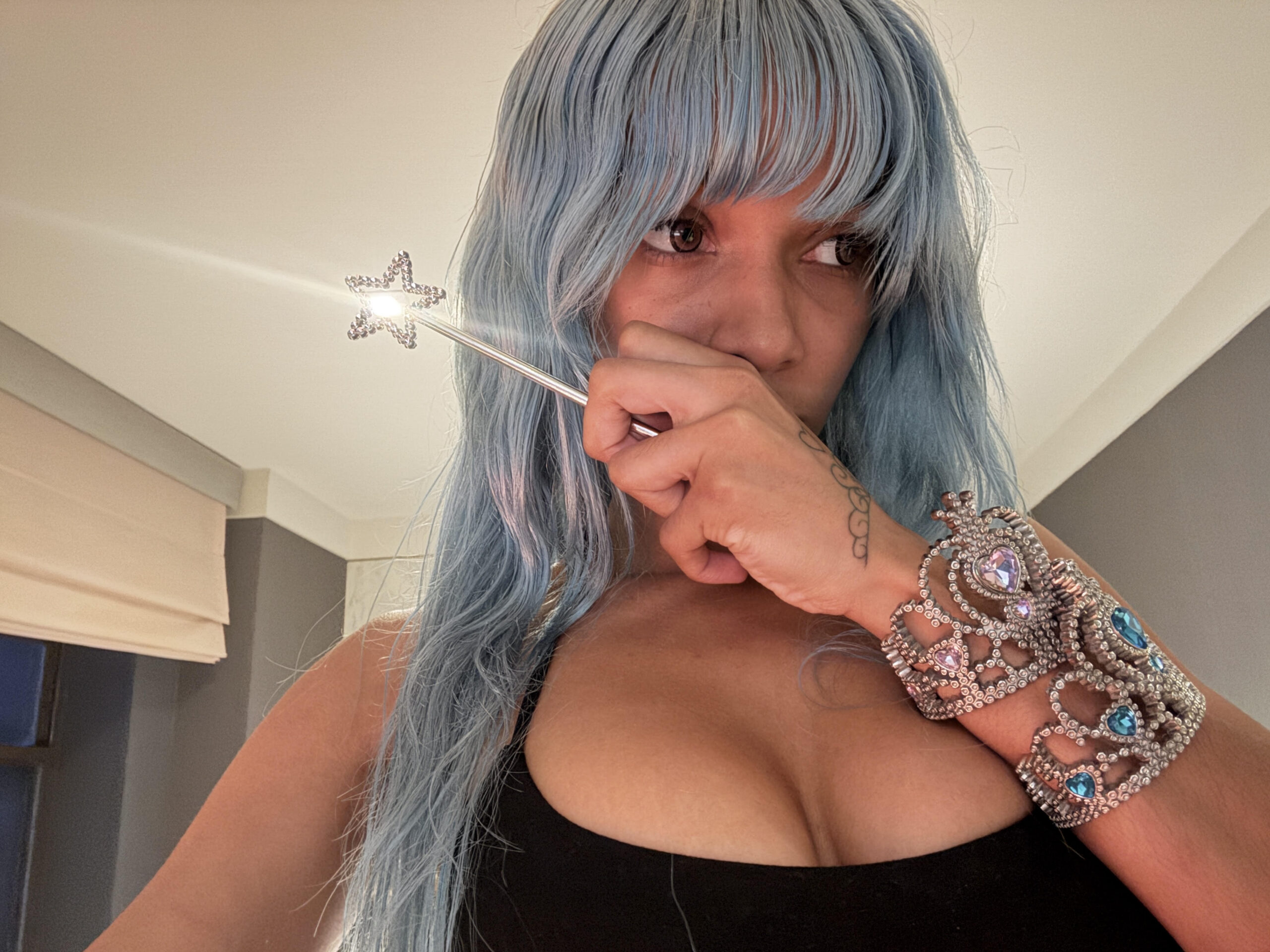 Cannelle holding a sparkly wand in a selfie