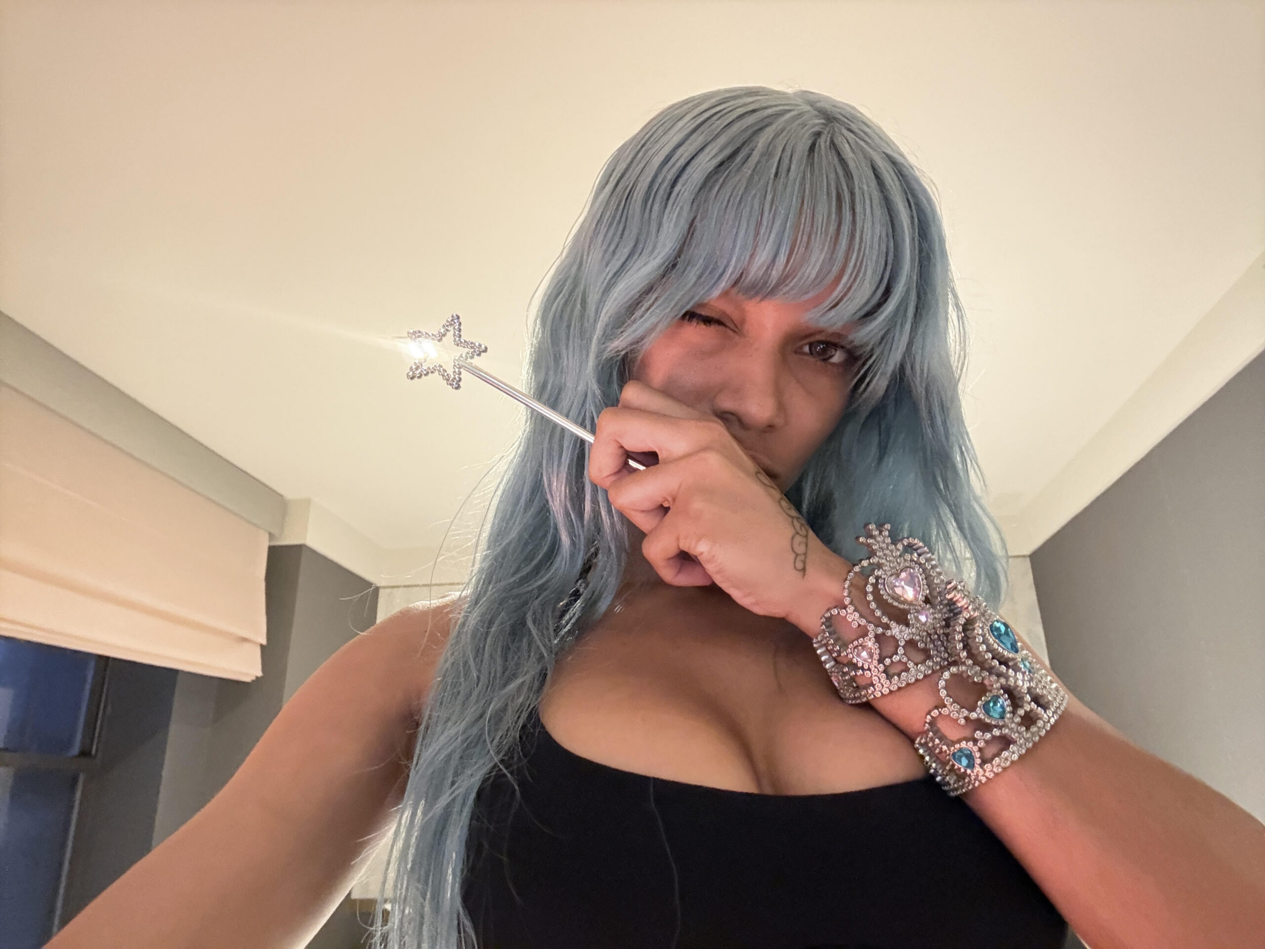 Cannelle holding a sparkly star wand in a selfie